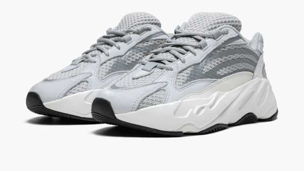View of white and grey Yeezy shoes.